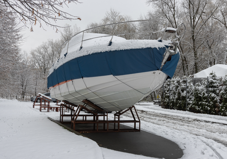 Winterized boat covered with snow